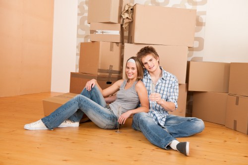 Professional movers handling household items during relocation in Kennington storage facility