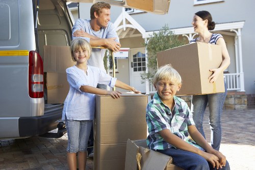 Professional movers handling furniture for a home relocation.